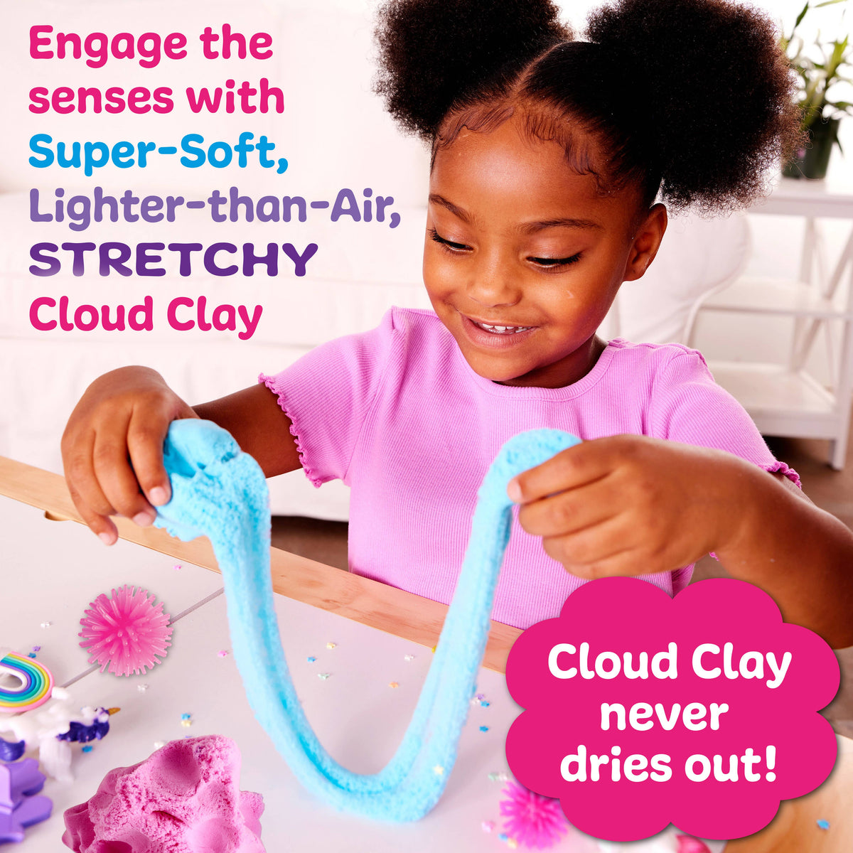 Child playing with blue Cloud Clay, surrounded by colorful decorations.