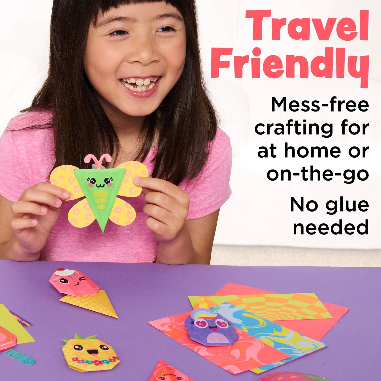 Child holding a colorful craft with text about travel-friendly mess-free crafting