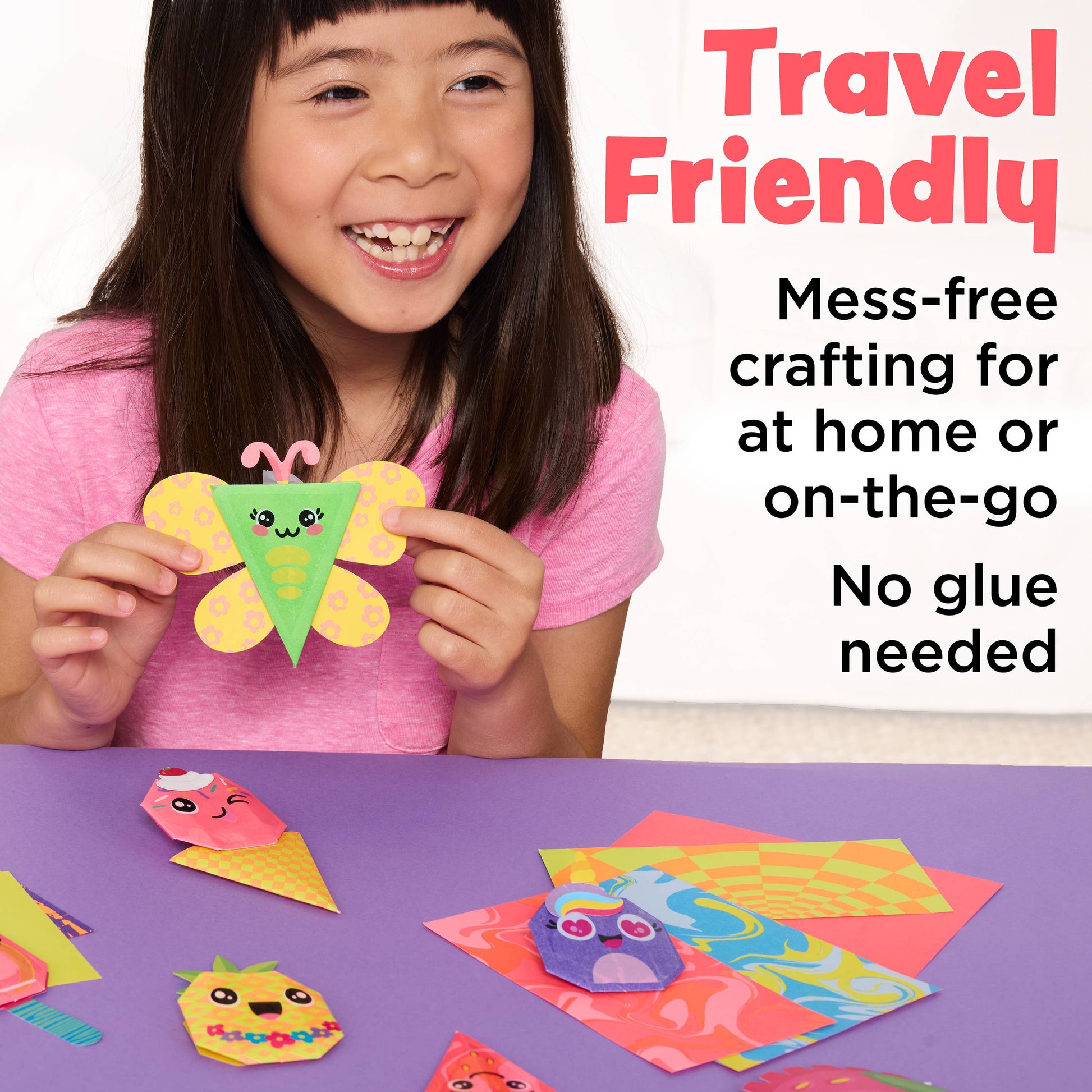 Child holding a colorful craft with text about travel-friendly mess-free crafting