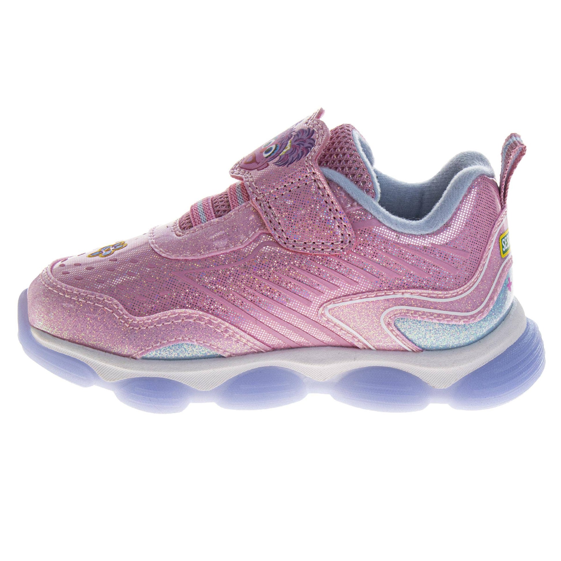 Pink children's shoe with blue sole on a white background