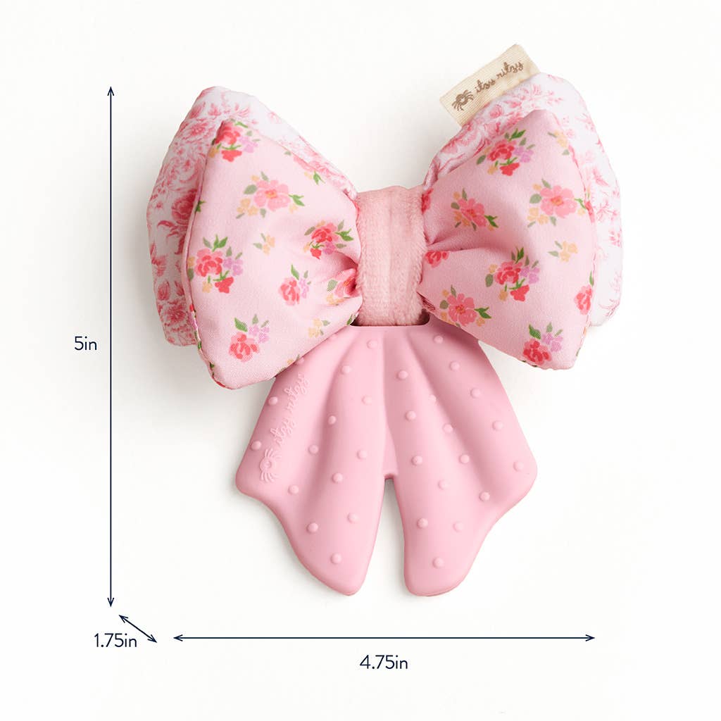 Pink bow-shaped crinkle teether  with floral pattern and measurements on a white background